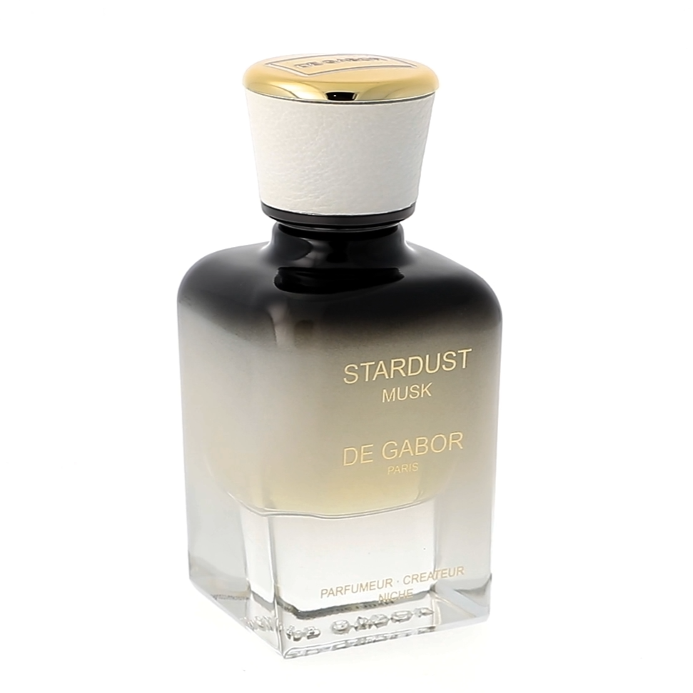 Perfume bottle labeled 'Stardust' by Serge Lutens on a white background