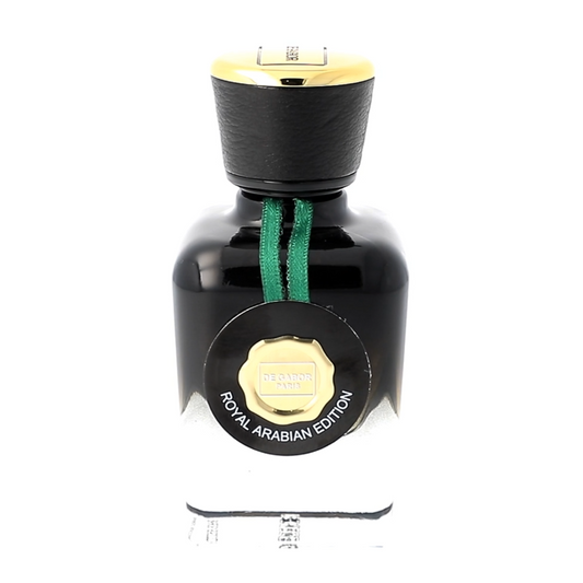 Perfume bottle with black cap and green ribbon on a white background
